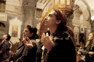 December 13 , 2012 , Damascus , Syria : Women pray during a preparatory mass before christmas at Al-Zaytoun Melkite Greek Catholic Church .