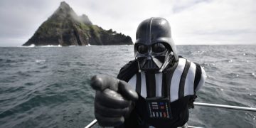 PORTMAGEE, IRELAND - MAY 04: A Star Wars fan dressed as the character Darth Vader takes a boat trip to the Skelligs on International Star Wars day May 4, 2018 in Portmagee, Ireland. The first ever Star Wars festival is taking place against the backdrop of the famous Skellig Michael island which was used extensively in Episode VII and Episode VIII of the popular science fiction saga. The small fishing village of Portmagee, which is closest to the location, has seen a boom in tourism following the latest films. The vilage will host a Star Wars drive-in and a Star Wars themed Irish dancing competition over the weekend. Today is known as 'May the fourth be with you' day. (Photo by Charles McQuillan/Getty Images)
